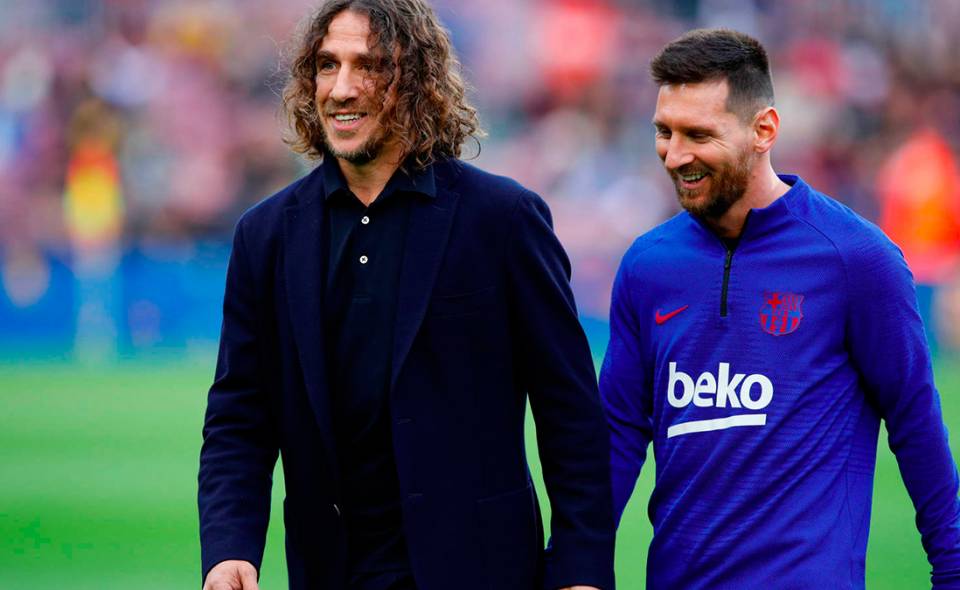 Carles Puyol y Leo Messi