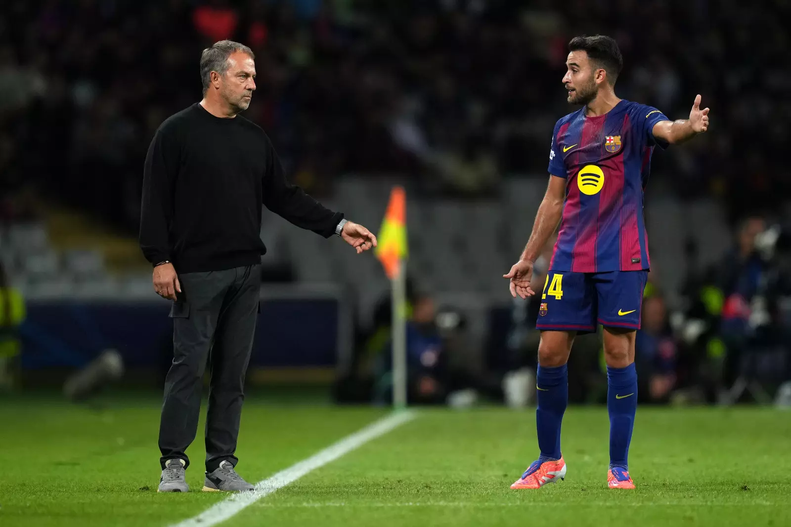 BARCELONA, SPAIN - OCTOBER 01: Hansi Flick, Head Coach of FC Barcelona, interacts with Eric Garcia of FC Barcelona during the UEFA Champions League 2025/26 League Phase MD2 match between FC Barcelona and Paris Saint-Germain at Estadi Olimpic Lluis Companys on October 01, 2025 in Barcelona, Spain. (Photo by Alex Caparros - UEFA/UEFA via Getty Images)