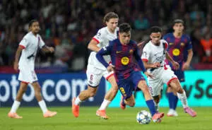 BARCELONA, SPAIN - OCTOBER 01: Pedri of FC Barcelona runs with the ball whilst under pressure from Illia Zabarnyi and Warren Zaire-Emery of Paris Saint-Germain during the UEFA Champions League 2025/26 League Phase MD2 match between FC Barcelona and Paris Saint-Germain at Estadi Olimpic Lluis Companys on October 01, 2025 in Barcelona, Spain. (Photo by Alex Caparros - UEFA/UEFA via Getty Images)
