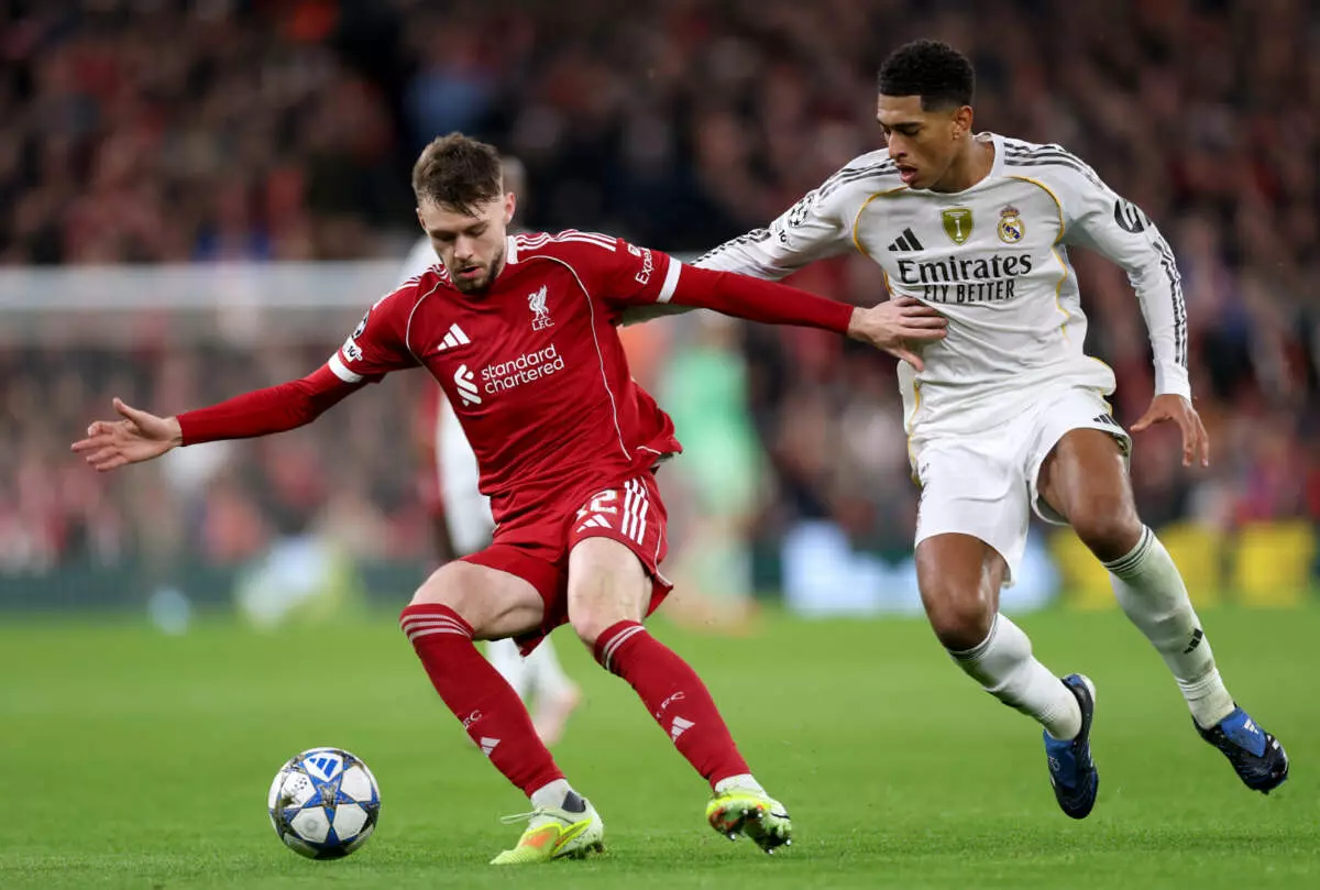LIVERPOOL, ENGLAND - NOVEMBER 04: Conor Bradley of Liverpool battles for possession with Jude Bellingham of Real Madrid during the UEFA Champions League 2025/26 League Phase MD4 match between Liverpool FC and Real Madrid C.F. at Anfield on November 04, 2025 in Liverpool, England. (Photo by Justin Setterfield - UEFA/UEFA via Getty Images)