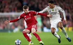 LIVERPOOL, ENGLAND - NOVEMBER 04: Conor Bradley of Liverpool battles for possession with Jude Bellingham of Real Madrid during the UEFA Champions League 2025/26 League Phase MD4 match between Liverpool FC and Real Madrid C.F. at Anfield on November 04, 2025 in Liverpool, England. (Photo by Justin Setterfield - UEFA/UEFA via Getty Images)