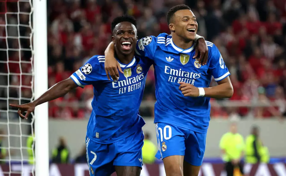 PIRAEUS, GREECE - NOVEMBER 26: Kylian Mbappe of Real Madrid (L) celebrates scoring his team's fourth goal with teammate Vinicius Junior (L) during the UEFA Champions League 2025/26 League Phase MD5 match between Olympiacos FC and Real Madrid C.F. at Stadio Georgios Karaiskakis on November 26, 2025 in Piraeus, Greece. (Photo by Alex Pantling - UEFA/UEFA via Getty Images)