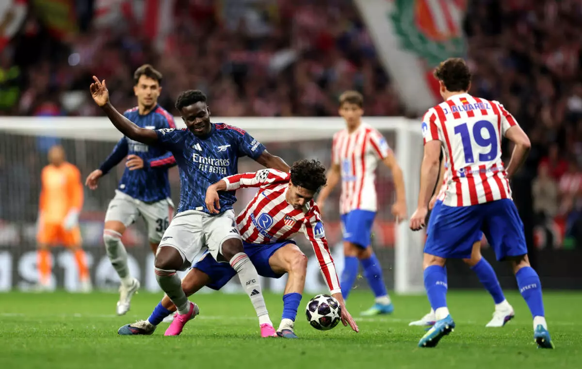 MADRID, SPAIN - APRIL 29: Johnny Cardoso of Atletico de Madrid is challenged by Bukayo Saka of Arsenal during the UEFA Champions League 2025/26 Semi Final First Leg match between Atletico de Madrid and Arsenal FC at Metropolitano Stadium on April 29, 2026 in Madrid, Spain. (Photo by Julian Finney - UEFA/UEFA via Getty Images)