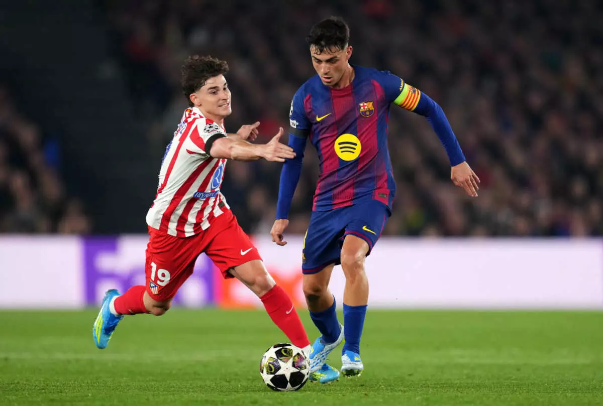 BARCELONA, SPAIN - APRIL 08: Pedri of FC Barcelona is challenged by Julian Alvarez of Atletico de Madrid during the UEFA Champions League 2025/26 Quarter-Final First Leg match between FC Barcelona and Club Atlético de Madrid at Camp Nou on April 08, 2026 in Barcelona, Spain. (Photo by Alex Caparros - UEFA/UEFA via Getty Images)