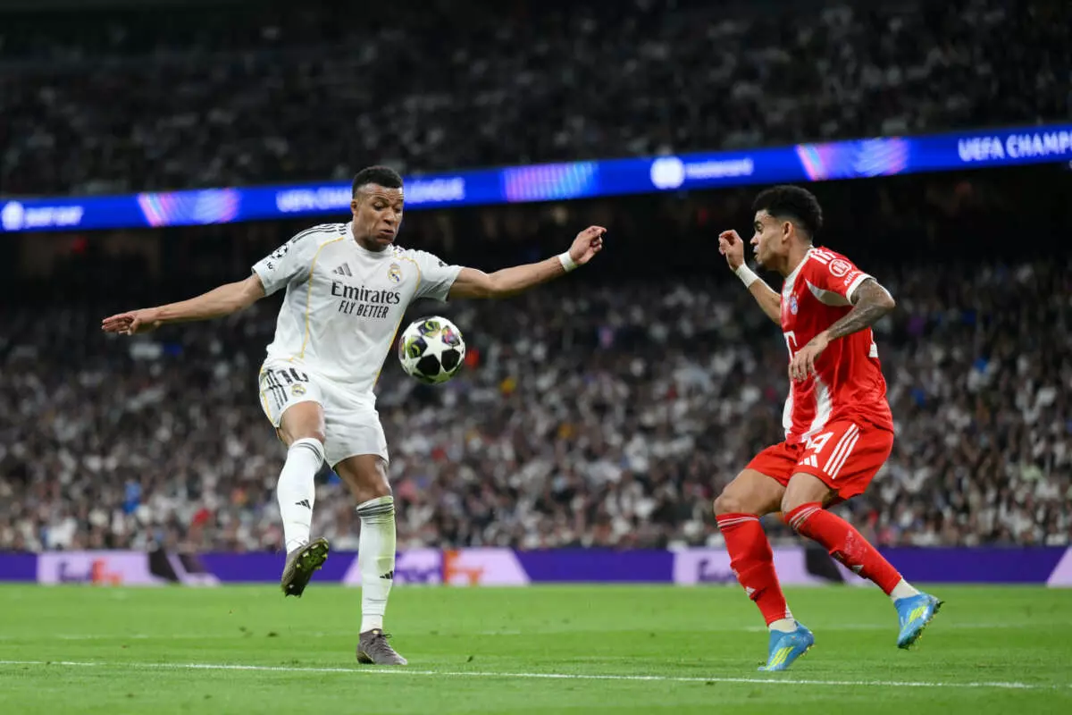 MADRID, SPAIN - APRIL 07: Kylian Mbappe of Real Madrid attempts to control the ball while under pressure from Luis Diaz of FC Bayern Munich during the UEFA Champions League 2025/26 Quarter-Final First Leg match between Real Madrid CF and FC Bayern München at Estadio Santiago Bernabeu on April 07, 2026 in Madrid, Spain. (Photo by David Ramos - UEFA/UEFA via Getty Images)